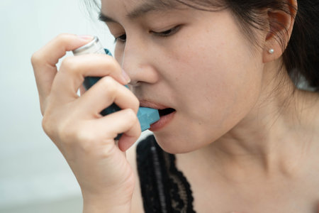 Asthma and chronic obstructive pulmonary disease COPD, Asian teenage using metered dose inhaler MDI.