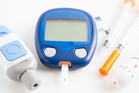 Glucometer lancet and test stick measuring human blood sugar level for diabetes.
