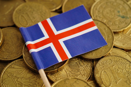 Iceland flag on coin and banknote money, finance trading investment business currency concept.の写真素材