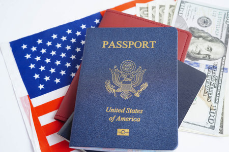 US passport issued to citizen and national of the United States of America to travel in most countries outside with USA flag and dollar money.の写真素材