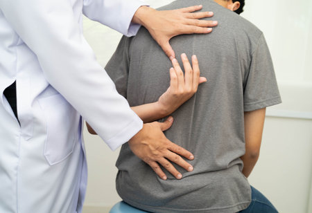 Physical therapy, Asian therapist doctor treat perform pain young man in hospital.