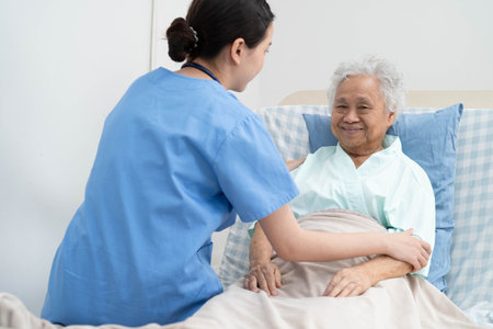 Asian doctor checking and treat elderly woman patient health in hospital.