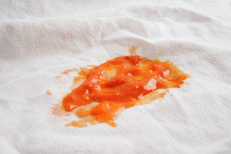 Dirty sauce stain on cloth to wash with washing powder, cleaning housework.
