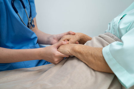 Asian doctor checking and treat elderly woman patient health in hospital.