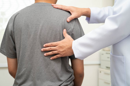 Physical therapy, Asian therapist doctor treat perform pain young man in hospital.