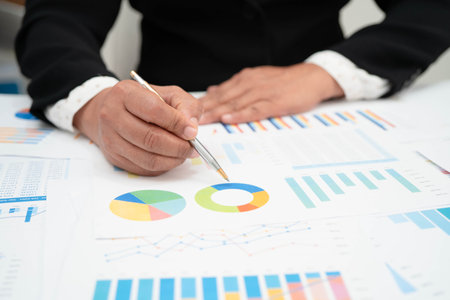Asian business woman working with financial graph.