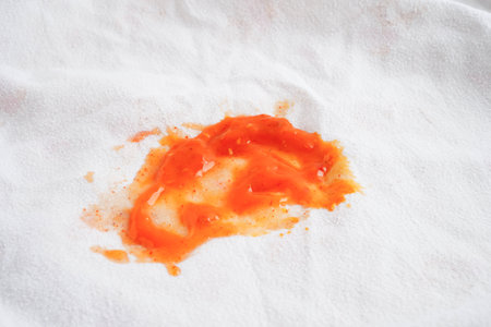 Dirty spicy sauce stain on cloth to wash with washing powder, cleaning housework.