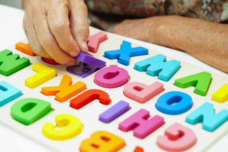 Asian elderly woman playing enhancing skill board game.の写真素材