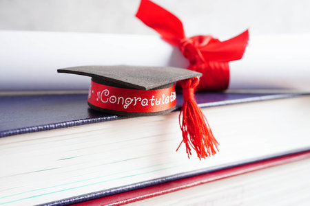 Graduation hat on book with copy space, learning university education.の写真素材