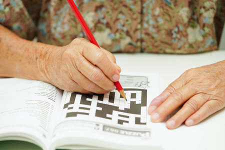 Bangkok, Thailand - May 15, 2022 elderly woman playing sudoku puzzle game.の写真素材