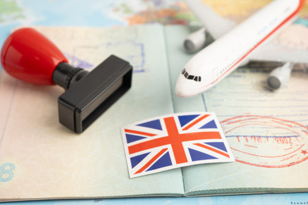 UK United Kingdom flag and passport with airplane for travel.