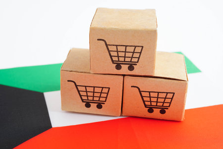 Online shopping, Shopping cart box on Kuwait flag, import export, finance commerce.