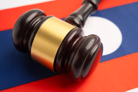 Laos, Legal, justice and agreement, wooden court gavel on flag.の写真素材