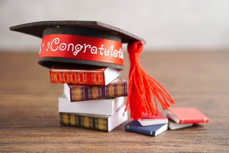 Graduation hat on book with copy space, learning university education.の写真素材