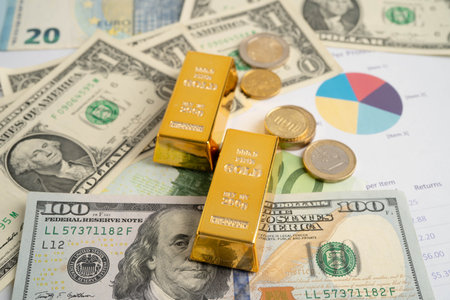 Gold bars with US dollar and Euro banknote money, finance trading investment business currency.の写真素材