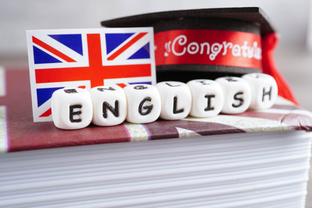 English book with graduate hat, learning and tutorial for foreigner.の写真素材