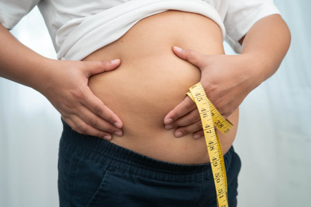 Asian woman use hand to squeeze fat belly big size overweight and obesity.