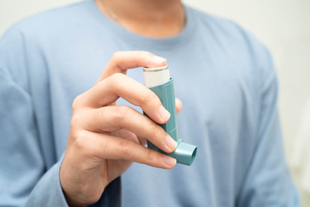 Asthma and chronic obstructive pulmonary disease COPD, Asian teenage using metered dose inhaler MDI.