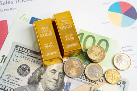 Gold bars with US dollar and Euro banknote money, finance trading investment business currency.の写真素材