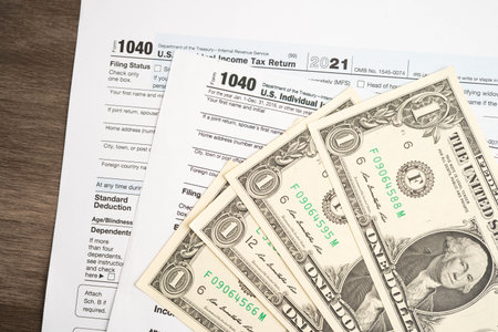 Tax form 1040 U.S. Individual Income Tax Return with dollar banknotes money.の写真素材