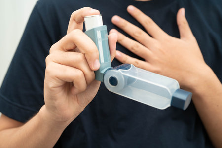 Asthma and chronic obstructive pulmonary disease COPD, Asian teenage using metered dose inhaler MDI.