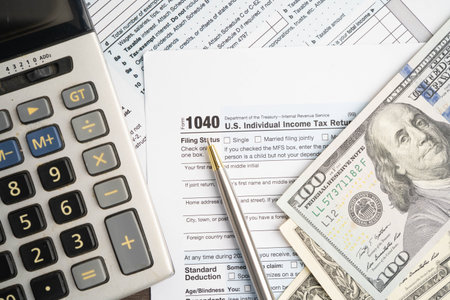 Tax form 1040 U.S. Individual Income Tax Return with dollar banknotes money.