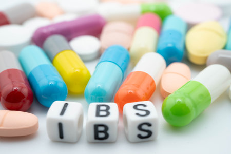 IBS Irritable bowel syndrome word with pills and capsules medical drug.