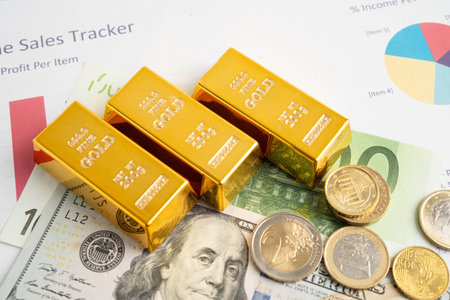 Gold bars with US dollar and Euro banknote money, finance trading investment business currency.