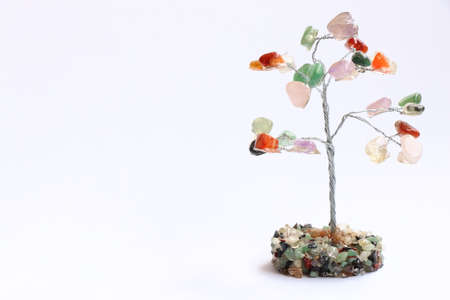 tree made of colored stones, with white background.