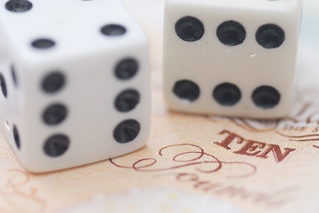 Two Dice on Bank Note, pound sterling.の写真素材