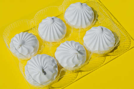 The wraparound packaging, in which there is a white delicate, sweet marshmallow, is located on a...