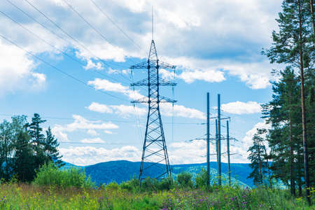 The electric transmission line is located on a large iron support in a beautiful natural setting