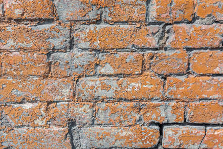 Old, antique wall of red destroyed bricks. The brickwork is made of bricks produced according to the old technologyの写真素材