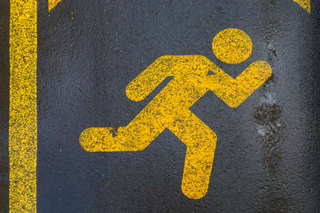 A treadmill sign on the pavement that is for running, walking or jogging only. Highlighted focus symbol.の写真素材