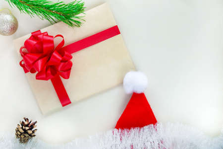 Kraft paper envelope tied with a red ribbon, Santa Claus hat. Conposition for Christmas and New...