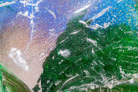 Beautiful, multi-colored surface of an old glass block. Cobblestone can be used as a background.