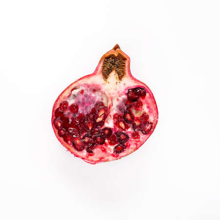 A funny slice of red pomegranate on a white background, similar to an electric light bulb. Isolated.の写真素材
