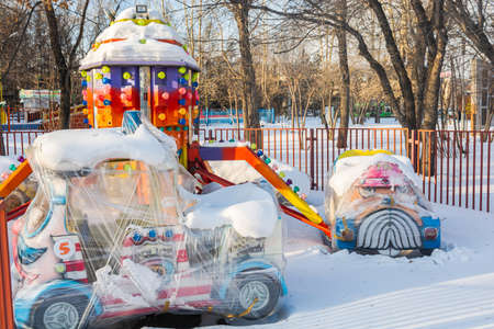 Krasnoyarsk, Russia - January 20, 2021: Children's carousel wrapped in film for winter in an amusement park.のeditorial素材