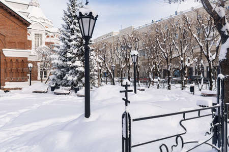 Krasnoyarsk, Russia - January 30, 2021: Heavy snowfall in the city. The fence and lantern of an Orthodox church.のeditorial素材