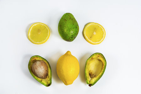 A pattern of slices and whole avocado and lemon. Isolated