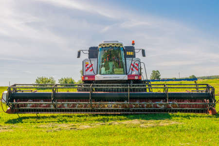 Krasnoyarsk, Russia - July 2, 2021: Agricultural harvester Rostselmash ACROS on the field during the harvest of grain crops.のeditorial素材