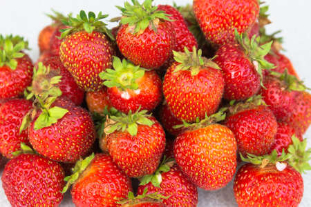 Heap of ripe red strawberries on a white background. Isolated.