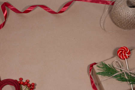 Gift in craft paper for Christmas and New Year. Holiday gift wrapping concept. Flat layの写真素材