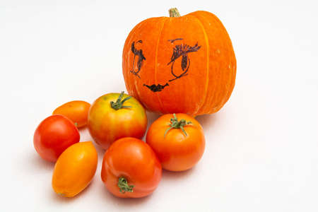 Ripe vegetables - pumpkin and tomatoes on a white background. Red and orange vegetables are a source of carotene.の写真素材
