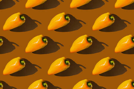 Bell pepper with shadow on brown background. Paprika pattern. Autumn concept.の写真素材