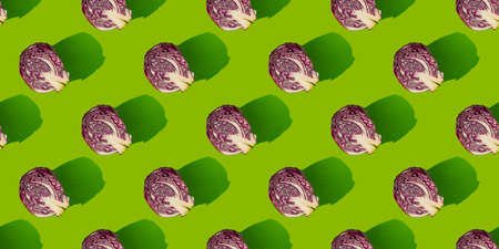 Pattern of slices of red cabbage on a green background. Autumn concept.