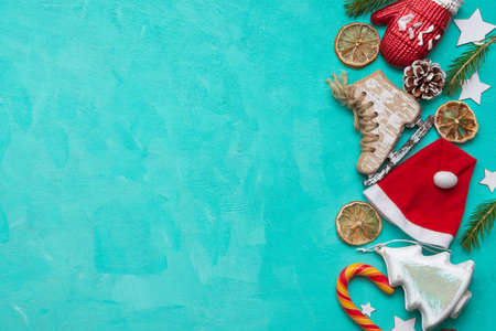 Christmas and New Years concept. Christmas decorations, sweets, Santa Claus hat on a green background. Flat lay. There is a place for text.の写真素材