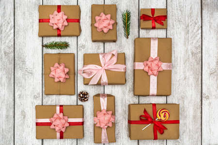 Nine holiday gifts are laid out on a white wooden background. New Year and Christmas concept. Flat lay.の写真素材