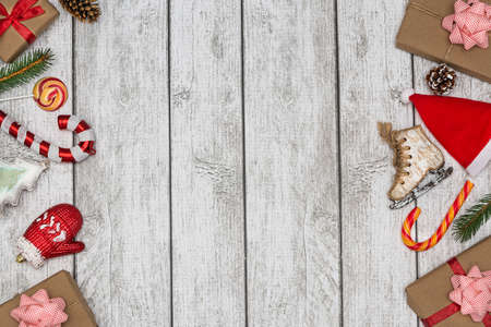 Holiday gifts, lollipops and Christmas tree decorations on a white wooden background. New Year and Christmas concept. Flat lay.の写真素材