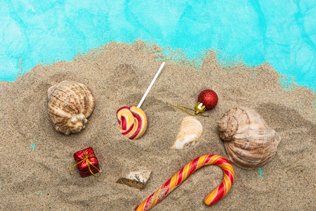 Sweets, gifts, seashells on the sand. Christmas sea travel concept.の写真素材